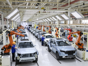 Chinese car factory scene showing workers on the production line